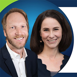 Three students sitting in front of a computer outside in the Quad
