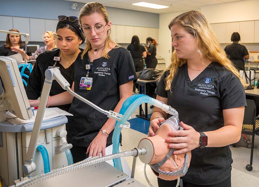 Multiple students working on respiratory machine