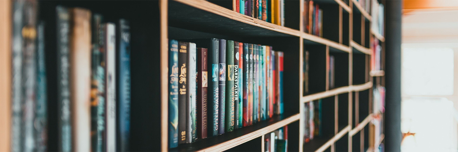 Books line shelves in a library