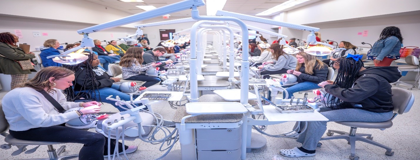 Area high school students working in the dental lab