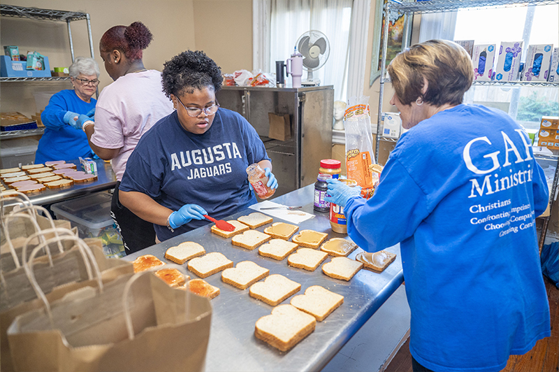 Augusta student works hard prepping sandwiches for Gap Ministries fresh Grab-and-Go lunches.