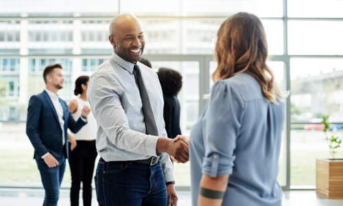 Educational Leadership shaking hand of a new hire