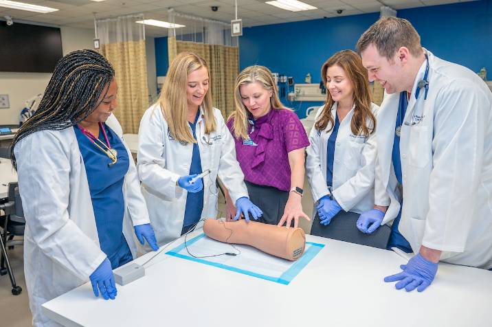 Graduate students practicing suturing