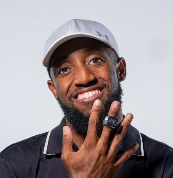 Man holding up hand with ring on it 