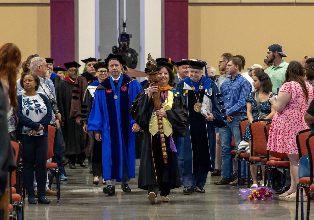 Faculty members entering convention center for commencement