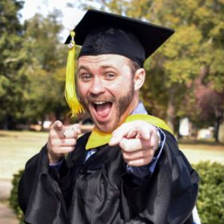 Excited graduate pointing at the viewer