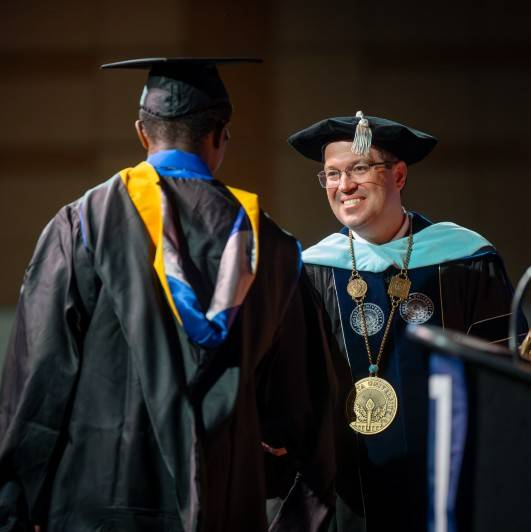 man smiling at a student
