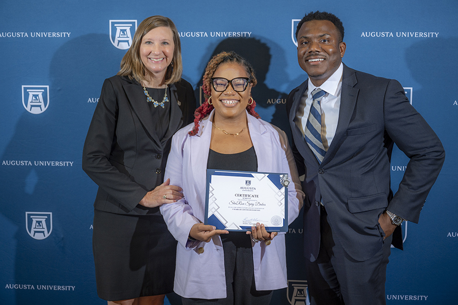 AU employees posing for picture at ceremony