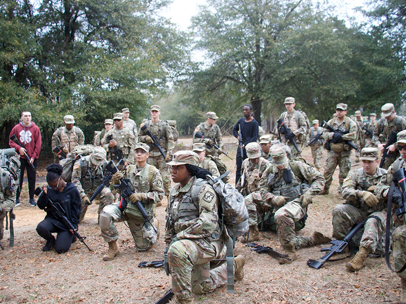 Cadets stand in group listening to brief