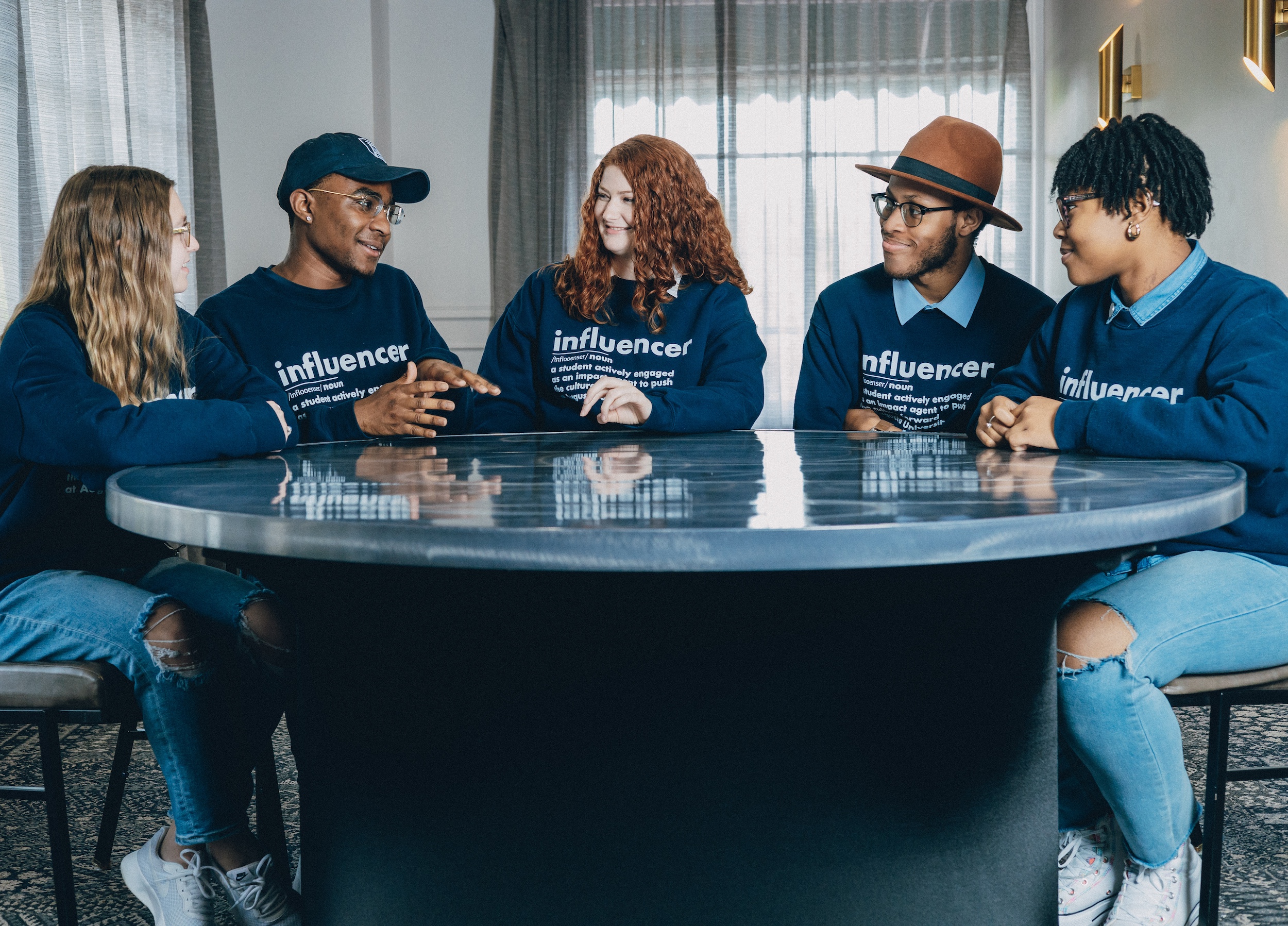 Augusta University influencers laughing at table